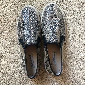 Faux snakeskin slip ons.